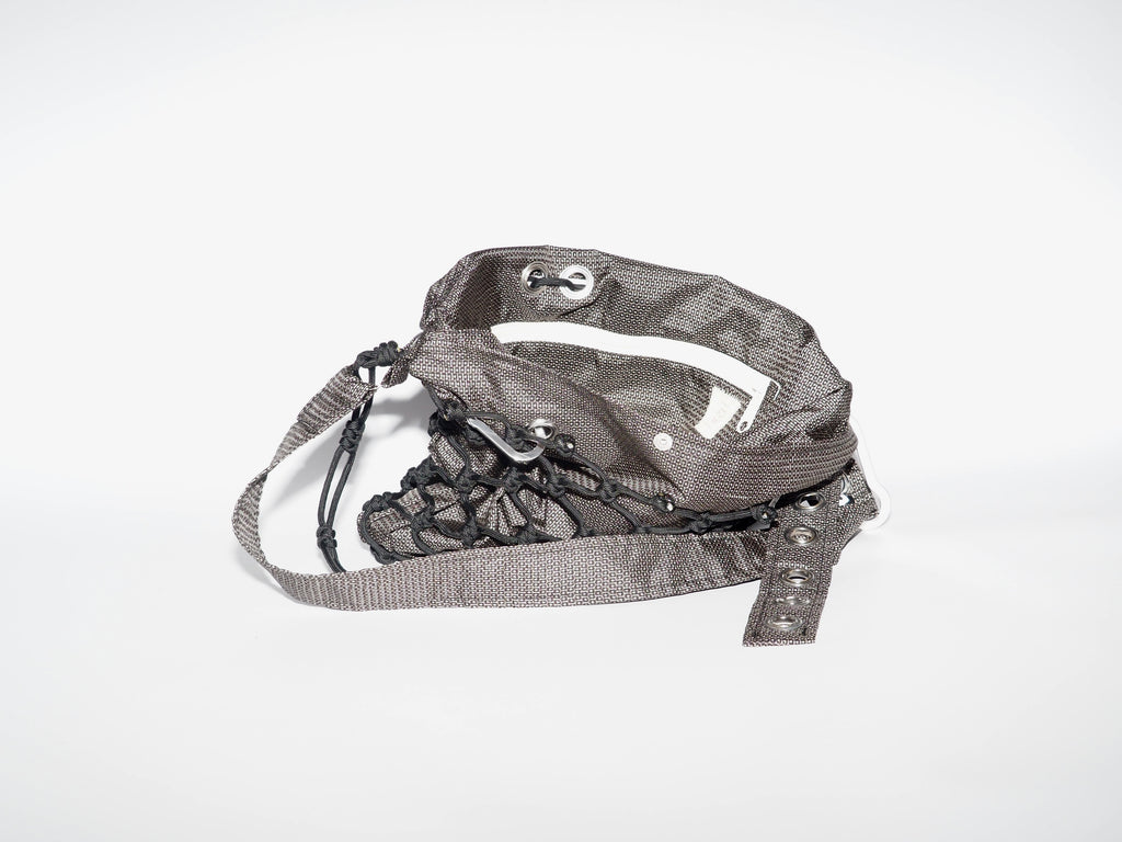 Handmade bag made of upcycled silk kimono and encased in a hand-knotted paracord. The fabric features black and white all-over print. The strap includes grommets and a carabiner for adjustability.