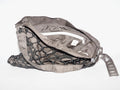 Handmade bag made of upcycled silk kimono and encased in a hand-knotted paracord. The fabric features black and white all-over print. The strap includes grommets and a carabiner for adjustability.