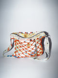 Handmade bag encased in hand-knotted paracord. Fabric is made by bay-area artis dymline. It features abstracts splatters and marks that are a natural by-product of their printing process.