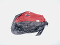 Handmade bag made of upcycled silk kimono and encased in a hand-knotted black paracord. The fabric features purply-black fabric with white stitching and a red interior. The strap includes grommets and a carabiner for adjustability.